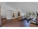 Large living room with hardwood floors, a comfortable sectional sofa, and views of the front yard at 8004 Village Green Rd, Orlando, FL 32818