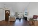 Inviting living room boasts hardwood floors, a plush sofa, and ample natural light from large windows at 8004 Village Green Rd, Orlando, FL 32818