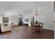 Spacious living area with hardwood floors, vaulted ceilings, and a comfortable seating arrangement at 8004 Village Green Rd, Orlando, FL 32818