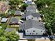 A beautiful aerial view of the property showcasing a modern home, with a manicured yard, and a detached garage at 833 Dartmouth St, Orlando, FL 32804