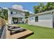 Wide angle shot of a backyard featuring a deck, artificial grass, and a covered patio at 833 Dartmouth St, Orlando, FL 32804
