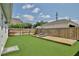 An ample backyard featuring lush artificial turf and a deck with lounge chairs, perfect for relaxing at 833 Dartmouth St, Orlando, FL 32804