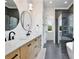 Bright bathroom with double vanity, soaking tub and glass shower with gray veined tile surround at 833 Dartmouth St, Orlando, FL 32804