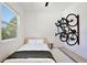 Bright bedroom with a bed, window and bikes mounted on the wall at 833 Dartmouth St, Orlando, FL 32804