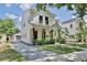 Well-manicured lawn and landscaping frame this contemporary two-story home, showcasing its elegant design at 833 Dartmouth St, Orlando, FL 32804