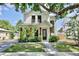 Stunning two-story home featuring a beautifully landscaped front yard and a charming covered entry at 833 Dartmouth St, Orlando, FL 32804