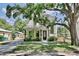 Charming two-story home featuring a beautifully landscaped front yard and a classic tree adding character at 833 Dartmouth St, Orlando, FL 32804