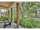 Inviting front porch features wooden pillars and a view of the lush, green neighborhood at 833 Dartmouth St, Orlando, FL 32804