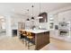 Modern kitchen with a large center island, pendant lighting, wine fridge, and stainless steel appliances at 833 Dartmouth St, Orlando, FL 32804
