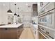 Bright kitchen boasts stainless appliances, sleek countertops, a large island, and modern pendant lighting at 833 Dartmouth St, Orlando, FL 32804