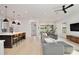 Open concept living room and kitchen features a large sectional sofa and modern finishes at 833 Dartmouth St, Orlando, FL 32804