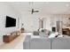 Bright living room seamlessly transitions into the modern kitchen with a breakfast bar at 833 Dartmouth St, Orlando, FL 32804