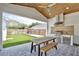 A beautiful outdoor kitchen and dining area that overlooks a pristine, fenced backyard at 833 Dartmouth St, Orlando, FL 32804