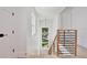 Bright stairway features wood treads, modern railings and a window overlooking green space to bring in light at 833 Dartmouth St, Orlando, FL 32804