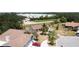 Aerial view of homes in a residential area with mature trees and landscaping at 857 E Flag Ln, Kissimmee, FL 34759