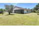 Exterior view of a home with a screened patio and spacious yard at 857 E Flag Ln, Kissimmee, FL 34759