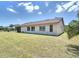 Well-maintained backyard with a covered patio and verdant green lawn at 857 E Flag Ln, Kissimmee, FL 34759