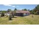 View of the back of the house from the lawn, with a screened lanai at 857 E Flag Ln, Kissimmee, FL 34759
