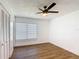 This bedroom features hardwood floors, a ceiling fan, and a closet at 857 E Flag Ln, Kissimmee, FL 34759