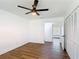 This bedroom features hardwood floors, a ceiling fan, and a closet at 857 E Flag Ln, Kissimmee, FL 34759