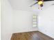 This bedroom features hardwood floors, a ceiling fan, and a window at 857 E Flag Ln, Kissimmee, FL 34759