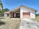 Charming single-story home featuring desert landscaping and a single-car garage at 857 E Flag Ln, Kissimmee, FL 34759