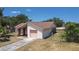 Exterior side view featuring a single car garage and fenced yard at 857 E Flag Ln, Kissimmee, FL 34759