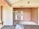 Inviting covered front porch with painted wood siding and light fixtures at 857 E Flag Ln, Kissimmee, FL 34759