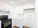 Bright, updated kitchen featuring white cabinets and modern black appliances at 857 E Flag Ln, Kissimmee, FL 34759