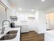 Updated kitchen with white cabinetry, stainless steel sink and modern fixtures at 857 E Flag Ln, Kissimmee, FL 34759