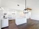 Bright kitchen with a modern island, white cabinets, and stylish pendant lighting at 857 E Flag Ln, Kissimmee, FL 34759