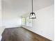 Bright living room boasting wood floors and ample natural light from large windows at 857 E Flag Ln, Kissimmee, FL 34759