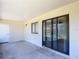 Spacious screened porch with concrete flooring, a window, and sliding glass doors to the outside at 857 E Flag Ln, Kissimmee, FL 34759