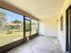 Enclosed porch featuring views of the landscaped backyard, screen windows, and access door at 857 E Flag Ln, Kissimmee, FL 34759