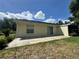 View of the backyard with a patio and sliding glass doors at 8829 Courtyard Ln, Groveland, FL 34736