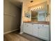 This bathroom features a sink with lots of light and storage at 8829 Courtyard Ln, Groveland, FL 34736
