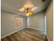 This light-filled bedroom features wood-look floors and a ceiling fan at 8829 Courtyard Ln, Groveland, FL 34736
