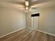 This bedroom features neutral walls, wood-look floors, and a ceiling fan at 8829 Courtyard Ln, Groveland, FL 34736