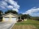Charming home with a well-manicured lawn, mature landscaping, and an attached two-car garage at 8829 Courtyard Ln, Groveland, FL 34736