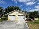 Charming home featuring a well-maintained two-car garage and lovely landscaping at 8829 Courtyard Ln, Groveland, FL 34736