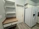Kitchen area featuring a desk space, a white refrigerator, and neutral walls at 8829 Courtyard Ln, Groveland, FL 34736