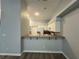 Bright and airy kitchen overlooking the living space with a breakfast bar and modern appliances at 8829 Courtyard Ln, Groveland, FL 34736