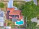 Aerial view of a home with solar panels, pool, fenced backyard, and tree shaded lot at 898 Hendry Dr, Orlando, FL 32822