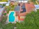 Aerial view of a home with solar panels, in-ground pool, large yard, and convenient access at 898 Hendry Dr, Orlando, FL 32822
