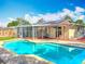 Backyard pool with sunroom, covered pergola, and brick-paver patio with mature trees in background at 898 Hendry Dr, Orlando, FL 32822
