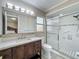 Bathroom featuring vanity, shower, toilet, and window with natural light at 898 Hendry Dr, Orlando, FL 32822