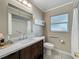 Bathroom with a dark wood vanity, tub and shower combination, and a frosted window at 898 Hendry Dr, Orlando, FL 32822
