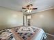 Cozy bedroom features a ceiling fan and a closet for ample storage at 898 Hendry Dr, Orlando, FL 32822