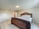 Bedroom featuring tan walls, tile flooring, and an elegant wooden bed frame at 898 Hendry Dr, Orlando, FL 32822
