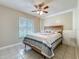 Well-lit bedroom featuring tiled floors and a bright window at 898 Hendry Dr, Orlando, FL 32822